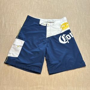 Corona Extra  Men’s navy blue and white with yellow board shorts. Size 32”